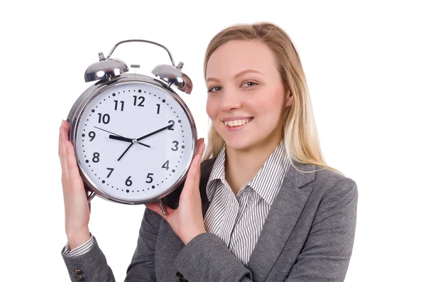 Mujer de negocios en traje gris con reloj despertador aislado en blanco — Foto de Stock