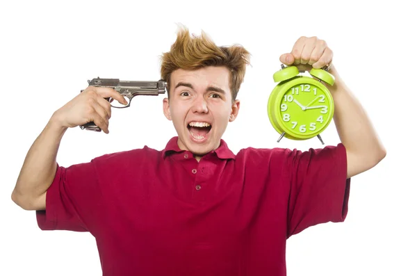 Estudiante sosteniendo reloj despertador y pistola aislada en blanco — Foto de Stock