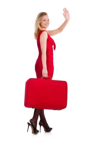 Smiling woman in red dress with suitcase isolated on white — Stock Photo, Image