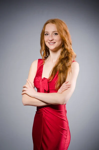 Girl in red dress against gray — Stock Photo, Image