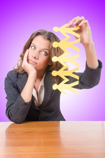 Businesswoman with paper people — Stock Photo, Image