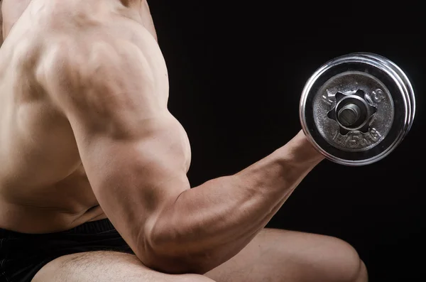 Muscular ripped bodybuilder with dumbbells — Stock Photo, Image