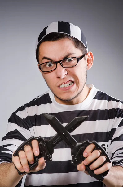 Young prisoner holding knifes — Stock Photo, Image