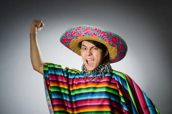 Man in vivid mexican poncho on gray — Stock Photo, Image