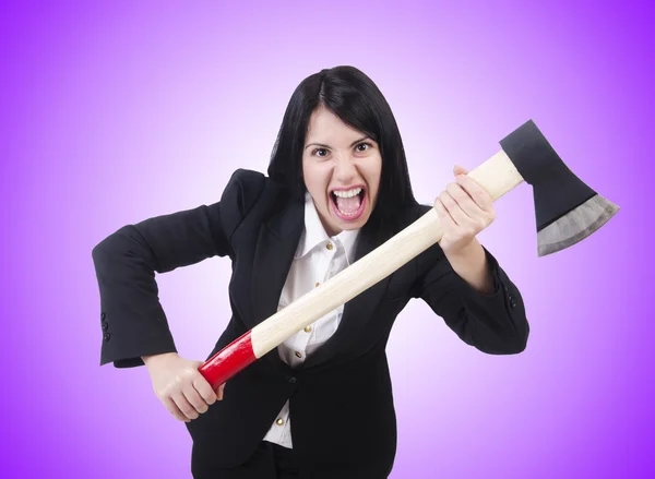 Angry businesswoman with axe on purple — Stock Photo, Image