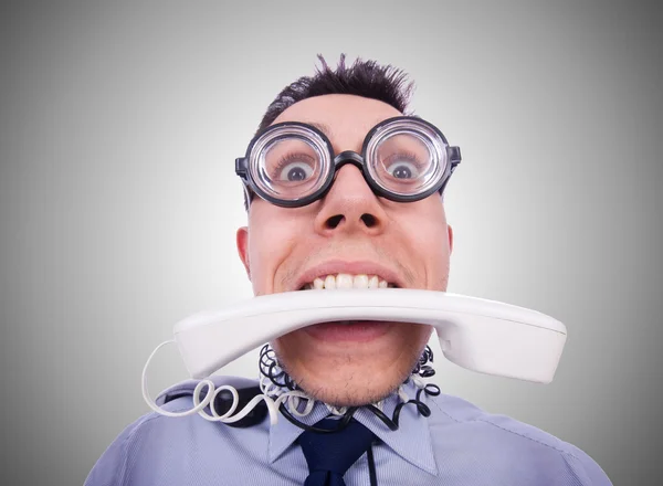 Crazy man with phone on grey — Stock Photo, Image