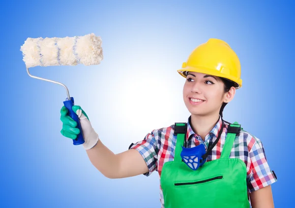 Woman painter with paintbrush on blue — Stock Photo, Image