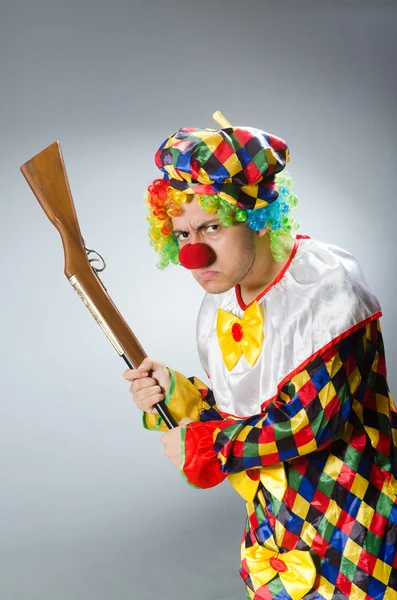 Clown with rifle isolated on white — Stock Photo, Image