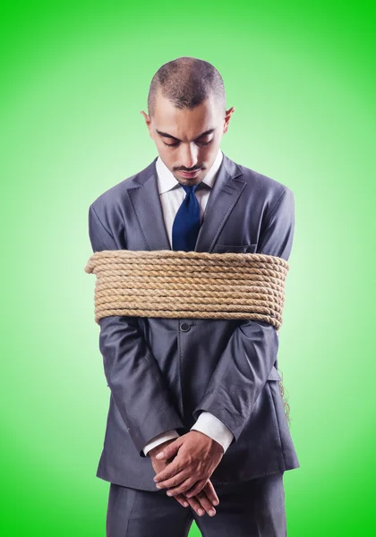 Businessman tied up with rope — Stock Photo, Image