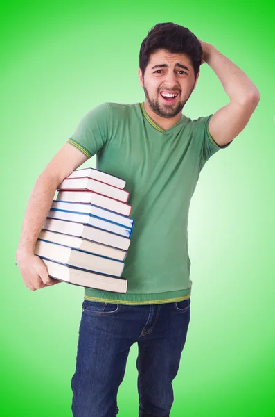 Étudiant avec beaucoup de livres sur le blanc — Photo