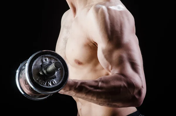 Muscular ripped bodybuilder with dumbbells — Stock Photo, Image