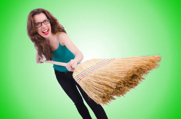 Young woman with broom isolated on white — Stock Photo, Image