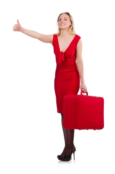 Mulher sorridente em vestido vermelho com mala isolada em branco — Fotografia de Stock