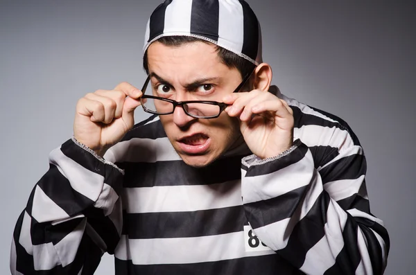 Young prisoner against gray — Stock Photo, Image