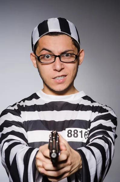 Young prisoner with handgun — Stock Photo, Image