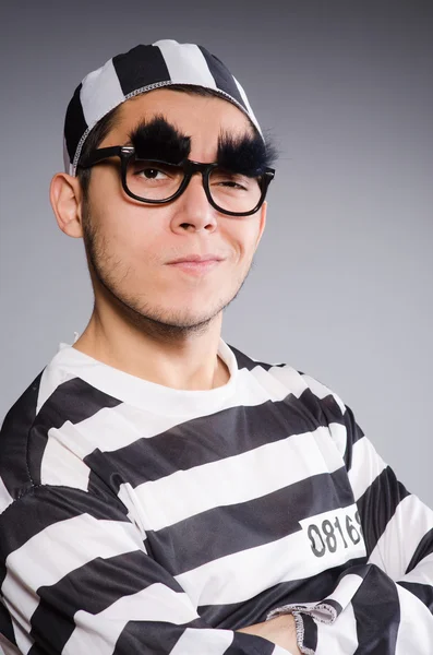 Young prisoner against gray — Stock Photo, Image