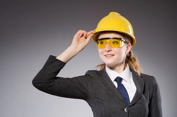 Construction worker in helmet against gray — Stock Photo, Image