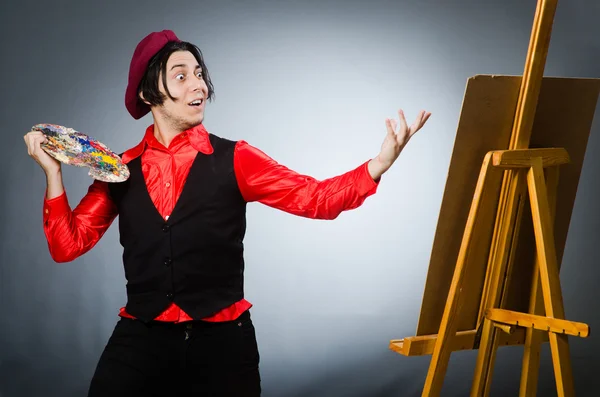 Funny artist in dark studio — Stock Photo, Image