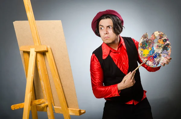 Funny artist in dark studio — Stock Photo, Image