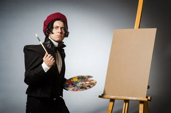 Funny artist in dark studio — Stock Photo, Image