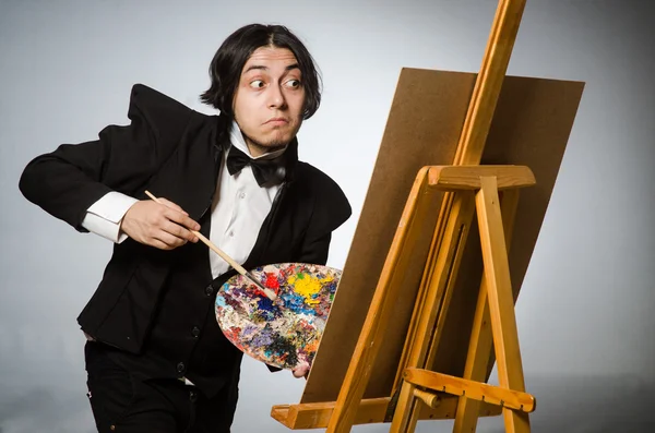 Funny artist in dark studio — Stock Photo, Image