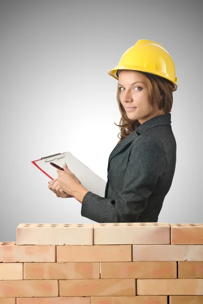 Woman architect near brick wall — Stock Photo, Image
