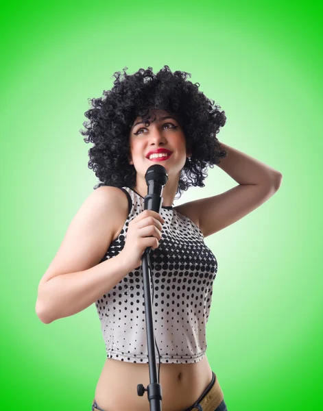 Pop star with mic  on green — Stock Photo, Image