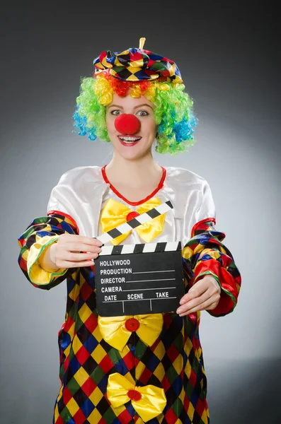 Clown with movie clapper in funny concept — Stock Photo, Image