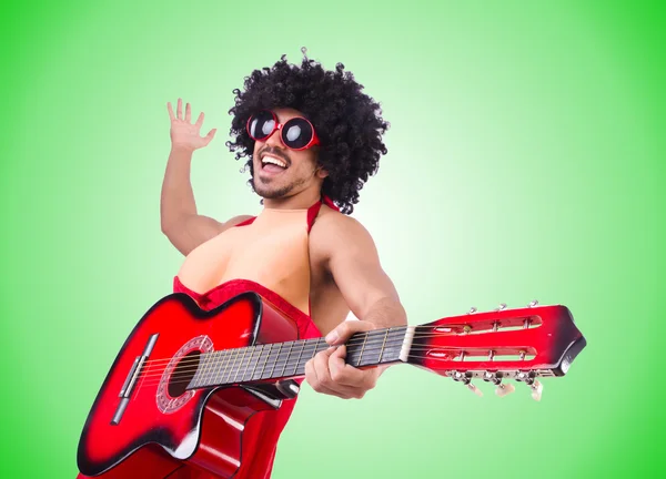 Man in woman clothing with guitar — Stock Photo, Image