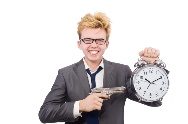 Joven hombre de negocios pistola holidng y reloj despertador aislado en blanco —  Fotos de Stock