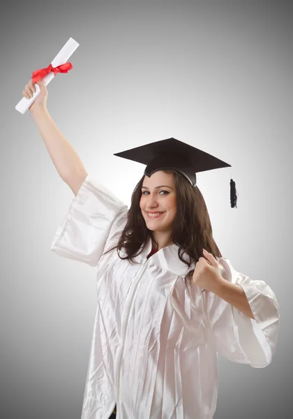 Examen med diplom på grå — Stockfoto