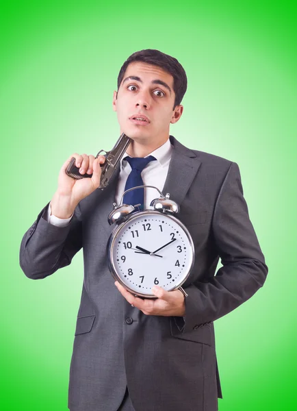 Man with gun and clock — Stock Photo, Image