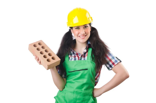 Trabajadora en mono verde sosteniendo ladrillo aislado en blanco — Foto de Stock