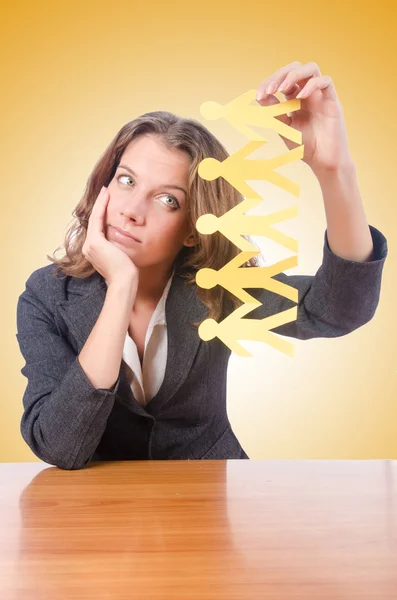 Businesswoman with paper people — Stock Photo, Image