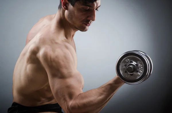 Muscular ripped bodybuilder with dumbbells — Stock Photo, Image