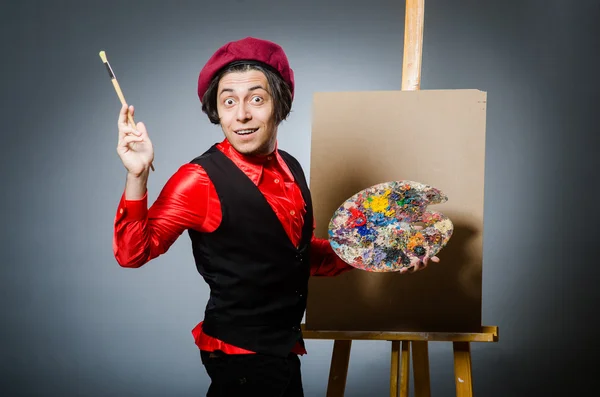 Funny artist in dark studio — Stock Photo, Image