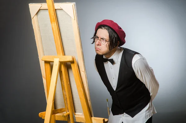 Funny artist in dark studio — Stock Photo, Image