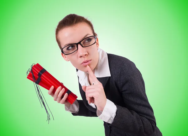 Businesswoman with dynamite on green — Stock Photo, Image