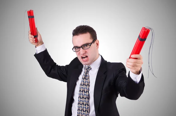 Businessman with dynamite isolated on gray — Stock Photo, Image