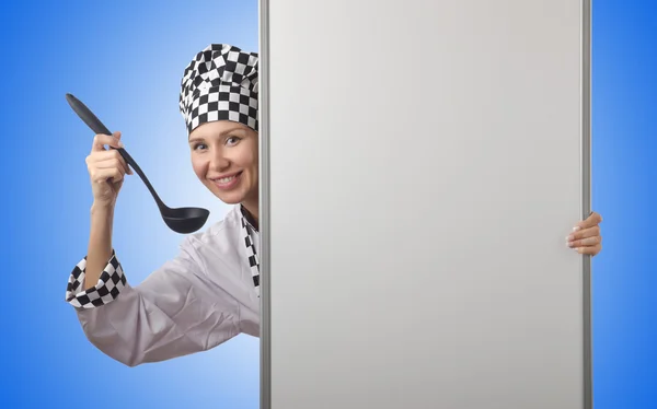 Cook with ladle and blank board — Stock Photo, Image