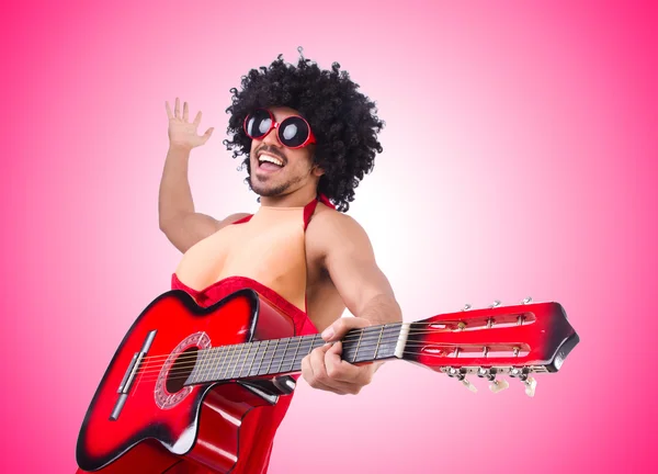 Man in woman clothing with guitar — Stock Photo, Image