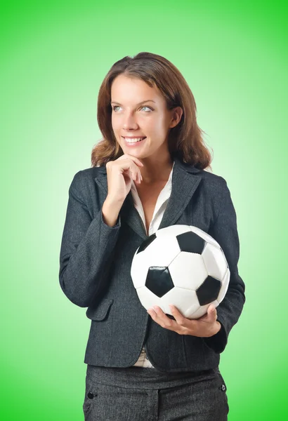 Businesswoman with football on green — Stock Photo, Image