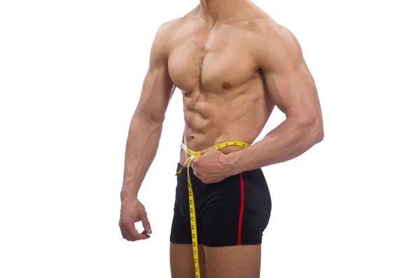 Muskulöser Mann misst seine Muskeln — Stockfoto