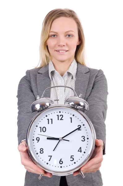白で隔離の目覚まし時計を保持しているグレーのスーツの女性実業家 — ストック写真