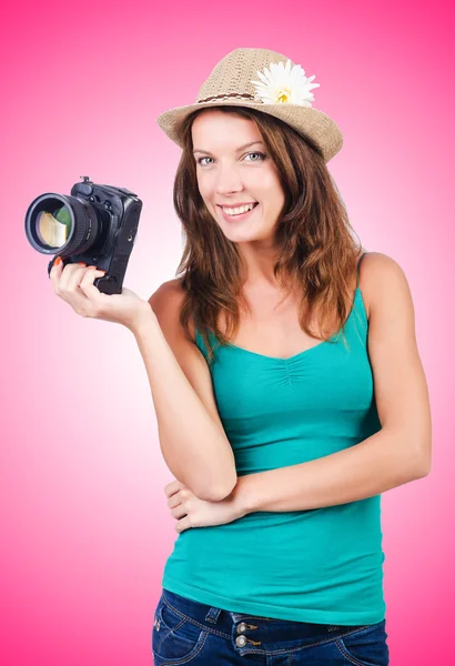 Attractive female photographer on pink — Stock Photo, Image