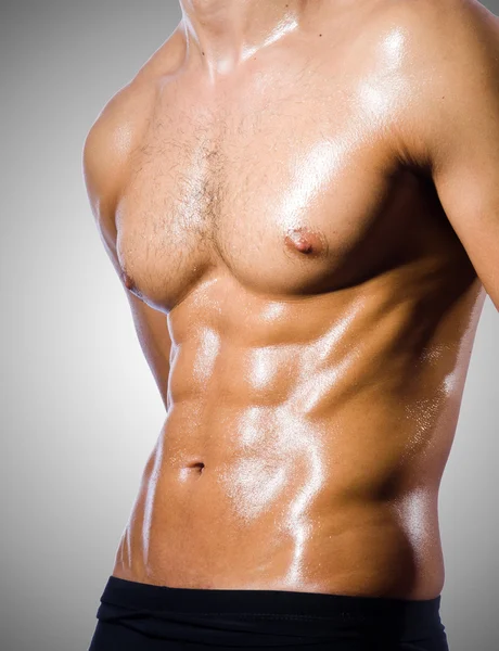 Muscular man isolated on the gray — Stock Photo, Image