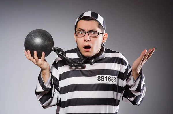 Young prisoner in chains against gray — Stock Photo, Image