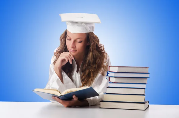 Happy graduate with lots of books — Stock Photo, Image