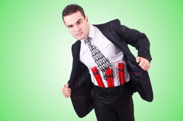 Businessman with dynamite isolated on green — Stock Photo, Image