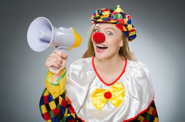 Clown with loudspeaker isolated on gray — Stock Photo, Image
